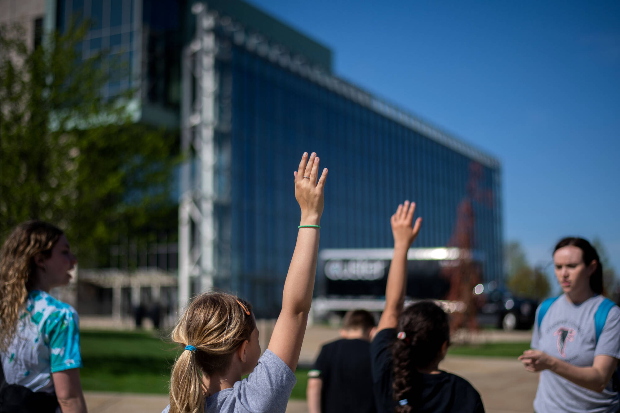 Kentwood’s Endeavor Elementary School students raise their hands to answer questions while walking to the Mary Idema Pew Library. The students were part of a multicultural leadership team that visited the Allendale Campus May 1.